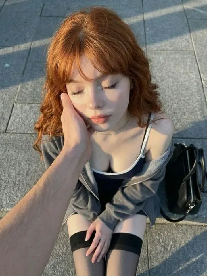 Natural red-haired AI girlfriend Ruby in warm sunlight